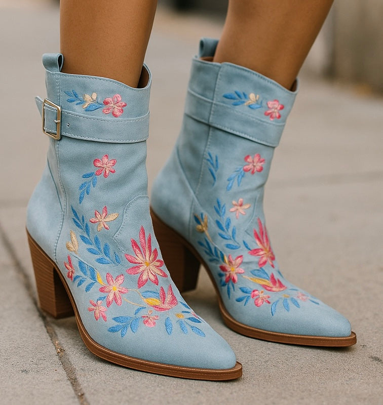 Pair of embroidered blue boots with floral details, heeled style.